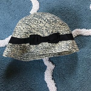 Straw hat with black ribbon and blue texture